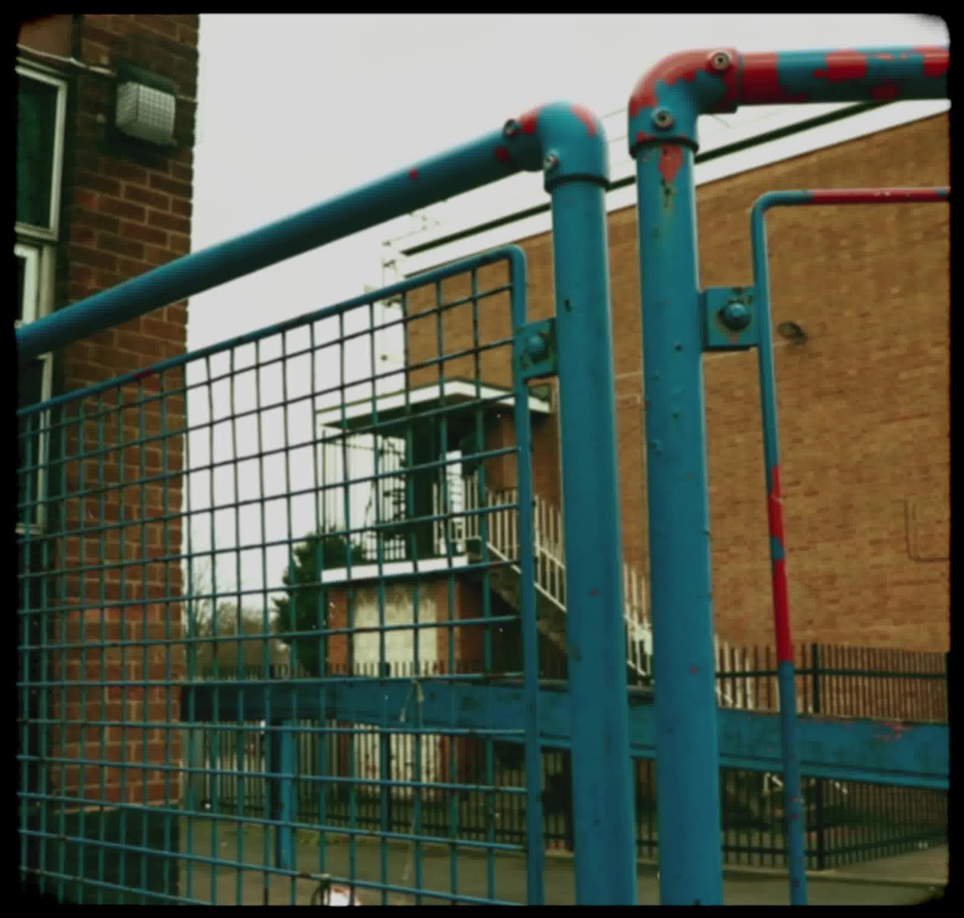 Vintage, film-like photography style with muted colors, soft focus, heavy grain, and black rounded borders, evoking a nostalgic, documentary feel.