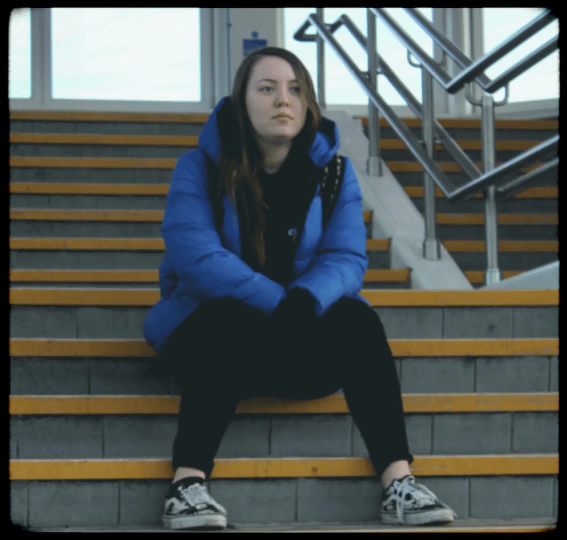 Vintage, film-like photography style with muted colors, soft focus, heavy grain, and black rounded borders, evoking a nostalgic, documentary feel.